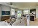 Open-concept living room seamlessly connected to the kitchen with access to an outdoor patio at 3828 Denali Dr, Apopka, FL 32712