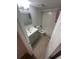 Bright bathroom features a gray vanity, illuminated mirror, toilet, and shower with pink floral shower curtain at 722 E Michigan St # 145, Orlando, FL 32806