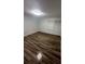 Comfortable bedroom with new floors, neutral walls, a large window for natural light, and modern light fixture at 722 E Michigan St # 145, Orlando, FL 32806