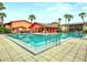 A large and inviting community pool surrounded by palm trees and lounging areas at 722 E Michigan St # 145, Orlando, FL 32806