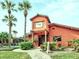 View of the cantina surrounded by palm trees and lush green grass at 722 E Michigan St # 145, Orlando, FL 32806