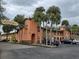 Condominium complex with lush landscaping and mature palm trees at 722 E Michigan St # 145, Orlando, FL 32806