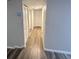 Hallway with new wood floors and a closet at 722 E Michigan St # 145, Orlando, FL 32806