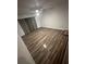 Spacious living room featuring new wood floors, neutral wall color, ceiling fan, and back patio access at 722 E Michigan St # 145, Orlando, FL 32806