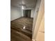 Spacious living room featuring new wood floors, neutral wall color, ceiling fan, and back patio access at 722 E Michigan St # 145, Orlando, FL 32806