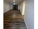 Open-concept living room featuring wood-look flooring at 722 E Michigan St # 145, Orlando, FL 32806