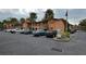 Exterior shot of the community with ample parking and manicured landscaping and mature palms at 722 E Michigan St # 145, Orlando, FL 32806