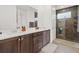 Stylish bathroom with double vanity, dark wood cabinets, and a glass-enclosed shower at 8750 Sw 79Th Loop, Ocala, FL 34481