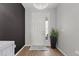 Bright foyer showcases a modern chandelier and stylish black accent wall at 8750 Sw 79Th Loop, Ocala, FL 34481
