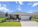 Attractive one-story home showcasing tidy landscaping, inviting entrance and a convenient two-car garage at 8750 Sw 79Th Loop, Ocala, FL 34481
