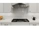 Stylish kitchen featuring a gas cooktop, designer backsplash, and modern appliances at 8750 Sw 79Th Loop, Ocala, FL 34481