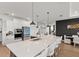 Well-lit kitchen with a large quartz countertop, stainless steel appliances, and an island at 8750 Sw 79Th Loop, Ocala, FL 34481
