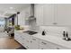 Modern kitchen with white cabinetry, stainless steel appliances, and a decorative backsplash at 8750 Sw 79Th Loop, Ocala, FL 34481