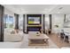 Living room boasts a modern fireplace, large windows, and seamless access to the kitchen at 8750 Sw 79Th Loop, Ocala, FL 34481