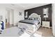 Bright main bedroom with elegant decor, black accent wall, and a plush rug at 8750 Sw 79Th Loop, Ocala, FL 34481