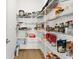 Well-organized pantry with abundant shelving offers ample storage space for food and supplies at 8750 Sw 79Th Loop, Ocala, FL 34481