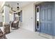 Inviting front porch featuring stone columns and comfortable seating at 8750 Sw 79Th Loop, Ocala, FL 34481