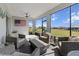 Cozy screened-in porch with wicker furniture, a ceiling fan, and views of the backyard at 8750 Sw 79Th Loop, Ocala, FL 34481