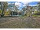 Back exterior view showing the home's screened-in patio and treed lot at 20995 Sw 93Rd Lane Rd, Dunnellon, FL 34431
