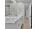 Bathroom features double sinks, modern fixtures, vanity, and a view into an open hallway at 20995 Sw 93Rd Lane Rd, Dunnellon, FL 34431