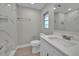 Bright bathroom featuring modern marble tiling, a large mirror, and a stylish vanity at 20995 Sw 93Rd Lane Rd, Dunnellon, FL 34431
