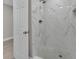 Bathroom shower featuring decorative marble tiling, a shower head, and a tiled shower floor at 20995 Sw 93Rd Lane Rd, Dunnellon, FL 34431