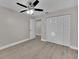 Bedroom featuring new wood-look flooring, closet with bi-fold doors and neutral paint at 20995 Sw 93Rd Lane Rd, Dunnellon, FL 34431