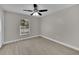 Bedroom features a ceiling fan, window and new wood-look flooring and neutral paint at 20995 Sw 93Rd Lane Rd, Dunnellon, FL 34431