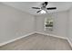 Neutral bedroom featuring a ceiling fan, window with blinds, and wood-look flooring at 20995 Sw 93Rd Lane Rd, Dunnellon, FL 34431