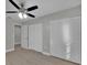 Bedroom showcasing new floors, bi-fold closet doors and neutral paint, leading into hallway at 20995 Sw 93Rd Lane Rd, Dunnellon, FL 34431