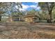 Lush property featuring mature trees and a well-maintained single-story home with unique stone facade at 20995 Sw 93Rd Lane Rd, Dunnellon, FL 34431