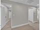 Bright hallway with wood-look flooring, doorways leading to other rooms and large closet doors at 20995 Sw 93Rd Lane Rd, Dunnellon, FL 34431