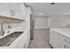 Kitchen area featuring stainless steel refrigerator and white cabinets at 20995 Sw 93Rd Lane Rd, Dunnellon, FL 34431