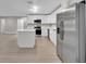 Spacious kitchen featuring stainless steel appliances, white cabinetry, island and modern flooring at 20995 Sw 93Rd Lane Rd, Dunnellon, FL 34431