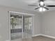 A bright living room with a ceiling fan and sliding glass doors at 20995 Sw 93Rd Lane Rd, Dunnellon, FL 34431