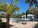 Community pool with lounge chairs, umbrellas, and lush landscaping in a serene setting at 20995 Sw 93Rd Lane Rd, Dunnellon, FL 34431