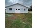 White and blue barn with double doors and barred windows at 36702 Calhoun Rd, Eustis, FL 32736