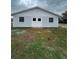 White and blue barn with double doors and barred windows at 36702 Calhoun Rd, Eustis, FL 32736