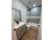 Stylish bathroom with grey tiled shower-tub combo and modern vanity at 36702 Calhoun Rd, Eustis, FL 32736