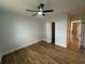 Bright bedroom features wood-look floors, ceiling fan, and closet at 36702 Calhoun Rd, Eustis, FL 32736