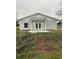Charming single-story home featuring a metal roof, double doors, and light gray siding at 36702 Calhoun Rd, Eustis, FL 32736