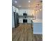 Beautiful kitchen features white cabinetry, stainless steel appliances, plank floors, and modern fixtures at 36702 Calhoun Rd, Eustis, FL 32736
