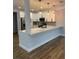 Modern kitchen featuring white cabinets, stainless steel appliances, plank flooring, and a breakfast bar at 36702 Calhoun Rd, Eustis, FL 32736