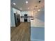 Modern kitchen featuring white cabinets, stainless steel appliances, plank flooring and modern fixtures at 36702 Calhoun Rd, Eustis, FL 32736