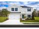 Charming two-story home with a well-manicured lawn, a two-car garage, and stylish architectural details at 4208 Cattail Marsh Dr, Lakeland, FL 33811