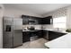 Sleek kitchen featuring stainless steel appliances, dark cabinetry, and quartz countertops for modern elegance at 4208 Cattail Marsh Dr, Lakeland, FL 33811