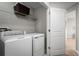Functional laundry area with modern washer and dryer, and convenient overhead storage at 4208 Cattail Marsh Dr, Lakeland, FL 33811
