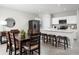 Open dining area with a table, chairs, and view of the kitchen and stainless steel appliances at 4214 Cattail Marsh Dr, Lakeland, FL 33811