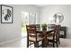 Cozy dining area with wood table, chairs, sliding glass doors, and a decorative plant at 4214 Cattail Marsh Dr, Lakeland, FL 33811