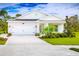 Charming single-story home with a well-manicured lawn and a bright blue front door at 4214 Cattail Marsh Dr, Lakeland, FL 33811